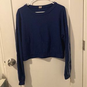 blue cropped long sleeve shirt with detailing on the arm